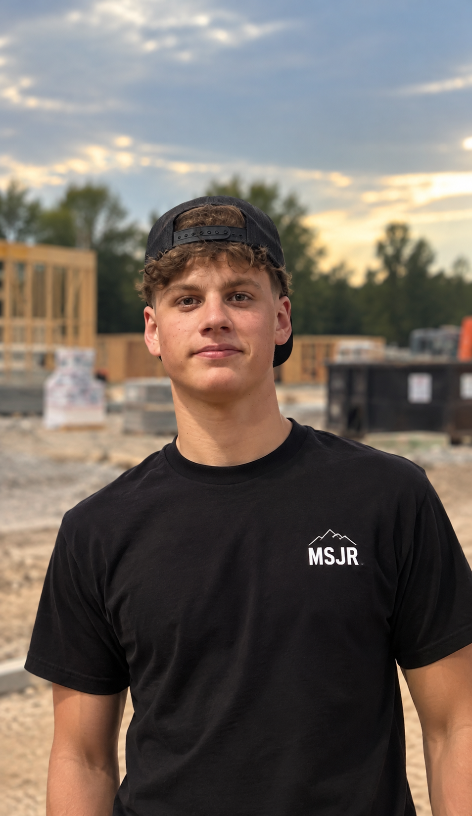 Evan Schatz of Mountain State Junk Removal wearing an MSJR shirt on a job site
